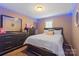 Bedroom featuring elegant neutral color scheme, complemented by a modern dresser and window at 8220 Terra Linda Ln, Charlotte, NC 28215