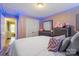 Bedroom featuring cozy lighting, with a dresser, mirror, and walk-in closet offering ample space at 8220 Terra Linda Ln, Charlotte, NC 28215
