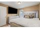 Well-lit bedroom with large-screen TV, comfortable bed, and stylish decor for a relaxed atmosphere at 8220 Terra Linda Ln, Charlotte, NC 28215