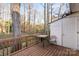 Exterior deck featuring wooden planks, a table with a chair, and beautiful natural surroundings at 8220 Terra Linda Ln, Charlotte, NC 28215