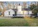 Charming exterior with a cozy front porch and white siding, surrounded by mature trees at 8220 Terra Linda Ln, Charlotte, NC 28215