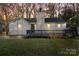 Charming exterior with a cozy front porch and white siding, surrounded by mature trees at 8220 Terra Linda Ln, Charlotte, NC 28215
