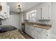 Traditional-style kitchen featuring white cabinets, granite countertops, and stainless steel appliances at 8220 Terra Linda Ln, Charlotte, NC 28215