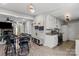 Open-concept kitchen and dining area with white cabinets and modern appliances, perfect for cooking and entertaining at 8220 Terra Linda Ln, Charlotte, NC 28215