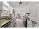 Well-lit kitchen featuring granite counters, white cabinets, stainless steel appliances, and wood flooring at 8220 Terra Linda Ln, Charlotte, NC 28215