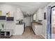 Bright kitchen with white cabinets, granite countertops, stainless steel appliances, and a wooden floor at 8220 Terra Linda Ln, Charlotte, NC 28215
