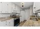 Well-lit kitchen with modern appliances, granite countertops, and classic white cabinetry at 8220 Terra Linda Ln, Charlotte, NC 28215