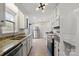 Well-lit kitchen featuring granite counters, white cabinets, stainless steel appliances, and wood flooring at 8220 Terra Linda Ln, Charlotte, NC 28215