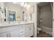 Contemporary bathroom featuring double sinks, a large mirror, and a shower-tub combination at 8650 Miles Gap Rd, Indian Land, SC 29707