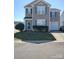 Charming two-story home featuring light gray siding, blue shutters, and a single-car attached garage at 9220 Pinaceal Ct, Charlotte, NC 28215