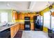 Open kitchen features a black appliance suite and tile flooring at 9220 Pinaceal Ct, Charlotte, NC 28215