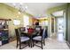 View of the dining room open to the living room with an abundance of natural light at 9220 Pinaceal Ct, Charlotte, NC 28215
