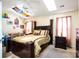 This primary bedroom features a ceiling fan, skylight, and comfy-looking bed at 9220 Pinaceal Ct, Charlotte, NC 28215