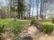Community playground surrounded by trees, a walking path, and open green space at 9220 Pinaceal Ct, Charlotte, NC 28215