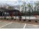 Community pool featuring a fenced enclosure, lounge chairs, and a covered pergola at 9220 Pinaceal Ct, Charlotte, NC 28215