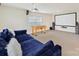Finished basement designed for entertainment with a projector screen, foosball table, and cozy blue sofa at 9895 Travertine Trl, Davidson, NC 28036