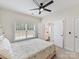 Bedroom featuring a ceiling fan, ensuite bathroom, and natural light from a window with blinds at 9895 Travertine Trl, Davidson, NC 28036