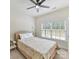 Cozy bedroom with ceiling fan, neutral tones, window with blinds, and decorative ladder at 9895 Travertine Trl, Davidson, NC 28036