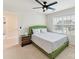 Inviting bedroom with a comfortable green bed and a decorative side table near a bright window at 9895 Travertine Trl, Davidson, NC 28036