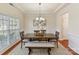 Formal dining room with tray ceiling, wainscoting, and a large window at 9895 Travertine Trl, Davidson, NC 28036