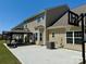 Rear exterior of the house featuring a patio, gazebo, and basketball hoop in the backyard at 9895 Travertine Trl, Davidson, NC 28036