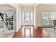 Elegant foyer with hardwood floors, decorative door with sidelights, and wainscoting at 9895 Travertine Trl, Davidson, NC 28036