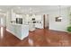 Spacious white kitchen features stainless appliances, kitchen island, hardwood floors and pendant lighting at 9895 Travertine Trl, Davidson, NC 28036