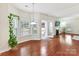 Bright living area with hardwood floors, fireplace, large windows overlooking backyard and a door to patio at 9895 Travertine Trl, Davidson, NC 28036