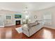 Cozy living room with a fireplace, hardwood floors, and plenty of natural light at 9895 Travertine Trl, Davidson, NC 28036