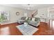 Comfortable living room with plush sectional sofa, modern lighting, and hardwood floors at 9895 Travertine Trl, Davidson, NC 28036