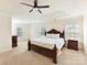 Spacious main bedroom with a dark wood bed frame, fan, and plenty of natural light at 9895 Travertine Trl, Davidson, NC 28036