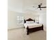 Large main bedroom features a dark wood bed frame, vaulted ceilings, and ceiling fan at 9895 Travertine Trl, Davidson, NC 28036