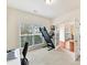 Well-lit home office featuring French doors, a large window, and comfortable workspace at 9895 Travertine Trl, Davidson, NC 28036