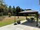 Outdoor patio with gazebo, dining set, basketball hoop, and a spacious lawn at 9895 Travertine Trl, Davidson, NC 28036