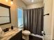 Bathroom featuring a window, updated fixtures and dark brown cabinetry at 1021 Mccollum Oaks Ln, Monroe, NC 28110