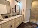 Bathroom with double sinks, granite countertop, and custom mirror at 1021 Mccollum Oaks Ln, Monroe, NC 28110