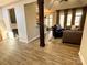 Open living room featuring a wooden pillar and hardwood floors at 1021 Mccollum Oaks Ln, Monroe, NC 28110