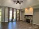 Open living room features wood floors, stone fireplace, recessed lighting and French doors to backyard at 1021 Mccollum Oaks Ln, Monroe, NC 28110