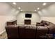 Cozy living room features recessed lighting, a fireplace, and a comfortable brown leather sofa at 1021 Mccollum Oaks Ln, Monroe, NC 28110