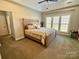 Bright main bedroom features a tray ceiling, neutral paint, and large windows at 1021 Mccollum Oaks Ln, Monroe, NC 28110