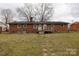 Expansive backyard showcasing the property's brick exterior, wooden deck, and ample green space at 103 Perry St, Shelby, NC 28150