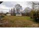 Large backyard with sheds, mature trees, and lawn at 103 Perry St, Shelby, NC 28150