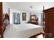 Cozy bedroom featuring a four-poster bed, dresser with a mirror, and matching curtains at 103 Perry St, Shelby, NC 28150