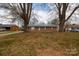 Charming brick home with mature trees, a welcoming front entrance, and classic curb appeal at 103 Perry St, Shelby, NC 28150