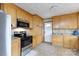 Well-lit kitchen with light wood cabinetry, tile backsplash, and modern stainless steel appliances at 103 Perry St, Shelby, NC 28150