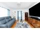 Comfortable living room with modern furnishings, hardwood floors, and natural light from the windows at 103 Perry St, Shelby, NC 28150