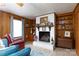 Comfortable living room featuring a brick fireplace with built-in shelving and tile flooring at 103 Perry St, Shelby, NC 28150