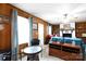 Cozy living room with wood paneling, a brick fireplace, and ample natural light at 103 Perry St, Shelby, NC 28150