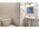 Powder room featuring a pedestal sink and updated fixtures at 10434 Henbane Ct, Charlotte, NC 28213