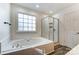 Bathroom featuring a soaking tub and a separate glass shower at 10434 Henbane Ct, Charlotte, NC 28213